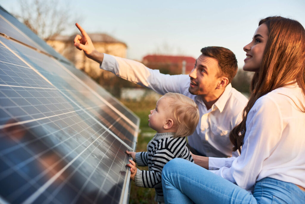 Family look at solar panels
